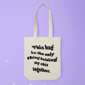 Canvas tote that says "This bag is the only thing holding my shit together."