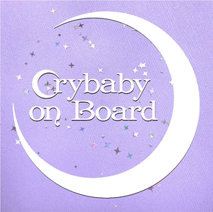 Vinyl cut out that says Crybaby on Board with a quarter moon around the words.